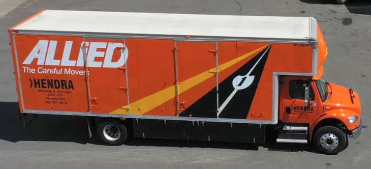 Hendra Moving and Storage orange moving truck on the road.