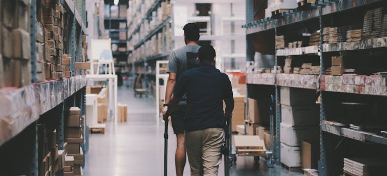 Men walking around a warehouse.