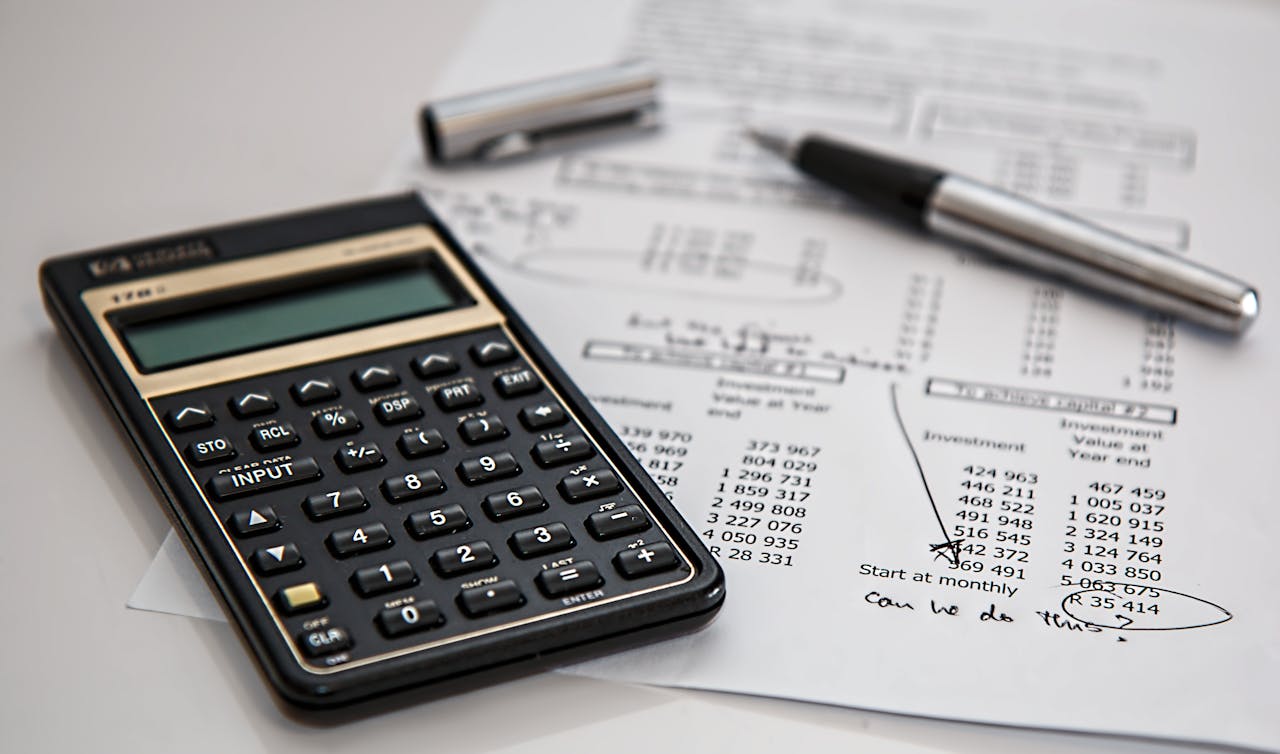 calculator and a paper with expenses to include in your moving budget.